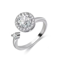 Silver ring with a large diamond and smaller diamonds on a white background