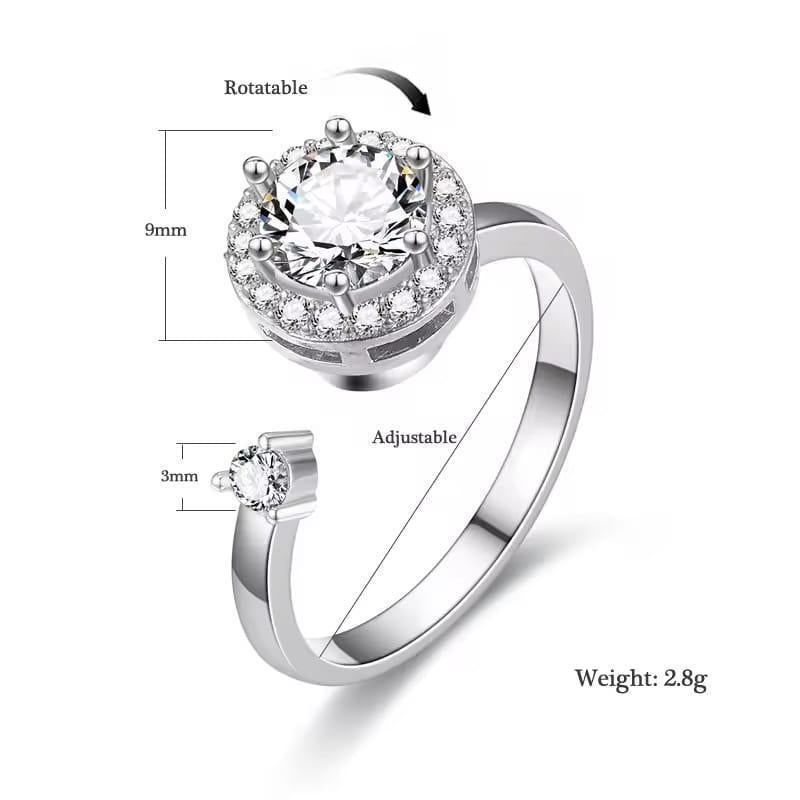Silver ring with a large central gemstone and smaller side gemstone, showing adjustable feature and measurements.