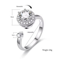 Silver ring with a large central gemstone and smaller side gemstone, showing adjustable feature and measurements.