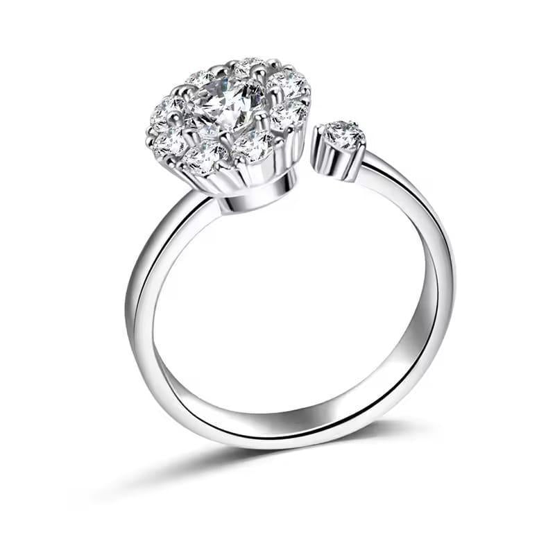 Silver ring with heart-shaped diamond on a white background