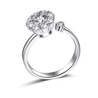 Silver ring with heart-shaped diamond on a white background